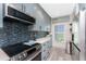 Modern kitchen features stainless steel appliances, quartz counters, and blue backsplash at 8405 Placida Rd # 406, Placida, FL 33946