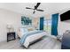 Main bedroom with king bed, luxury vinyl plank flooring, ceiling fan, and ensuite bathroom at 8405 Placida Rd # 406, Placida, FL 33946