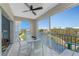 Relax on this screened patio with outdoor dining set and views of the canal and landscaping at 8405 Placida Rd # 406, Placida, FL 33946