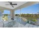 Enjoy the view from this screened patio with an outdoor seating area and ceiling fan at 8405 Placida Rd # 406, Placida, FL 33946