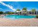 Beautiful pool with clear water, lounge chairs and palm trees under a sunny blue sky at 8405 Placida Rd # 406, Placida, FL 33946