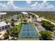 Scenic aerial of the community's tennis courts with the pond and clubhouse in the background at 8405 Placida Rd # 406, Placida, FL 33946