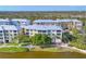 Community buildings featuring water views, lush landscaping, and exterior amenities at 8411 Placida Rd # 404, Placida, FL 33946