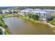 Lakeside building with beautifully maintained landscaping and serene water views at 8411 Placida Rd # 404, Placida, FL 33946