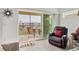 Balcony boasts chairs and a table overlooking green space and other community buildings at 8411 Placida Rd # 404, Placida, FL 33946