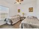 Comfortable bedroom with twin beds, carpeted floors, and large window at 8411 Placida Rd # 404, Placida, FL 33946