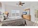 Comfortable bedroom featuring a ceiling fan, dresser, and view of the screened-in patio at 8411 Placida Rd # 404, Placida, FL 33946