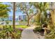 Water view and a winding sidewalk through a lush landscape at 8411 Placida Rd # 404, Placida, FL 33946