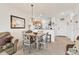 Cozy dining room with tiled floors, chandelier, table with four chairs, and access to the kitchen at 8411 Placida Rd # 404, Placida, FL 33946