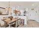 Bright dining space features a table with four chairs, tiled floors, recessed lighting, and kitchen view at 8411 Placida Rd # 404, Placida, FL 33946