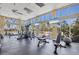 Well-equipped gym with large windows offering views of the pool and palm trees at 8411 Placida Rd # 404, Placida, FL 33946