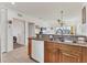 Modern kitchen features granite counters, wood cabinets, stainless appliances, and open layout to living area at 8411 Placida Rd # 404, Placida, FL 33946