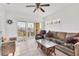 Bright living room showcasing comfortable seating, tiled floors, and access to a private balcony at 8411 Placida Rd # 404, Placida, FL 33946