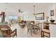 Bright open-concept living space with tiled floors, ceiling fan, sliding doors to balcony, and adjacent dining area at 8411 Placida Rd # 404, Placida, FL 33946