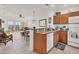 Open-concept with kitchen overlooking living space: tile floors, breakfast bar, and sliding doors to balcony at 8411 Placida Rd # 404, Placida, FL 33946
