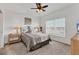 Comfortable main bedroom with large window, ceiling fan, carpeted floor, and neutral decor at 8411 Placida Rd # 404, Placida, FL 33946