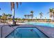 Inviting swimming pool and hot tub area surrounded by palm trees and lounge chairs at 8411 Placida Rd # 404, Placida, FL 33946