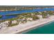 Scenic aerial shot of a coastal home with waterfront views, highlighting its proximity to the beach and river at 8500 Manasota Key Rd, Englewood, FL 34223