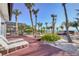 Outdoor deck with lounge chairs overlooking a tropical beach and clear blue water at 8500 Manasota Key Rd, Englewood, FL 34223