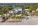 Aerial view of a beachfront home with a pool and tropical landscaping at 8500 Manasota Key Rd, Englewood, FL 34223