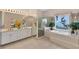 Spacious bathroom with double vanity, soaking tub, glass shower, and ocean view at 8500 Manasota Key Rd, Englewood, FL 34223