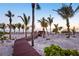 Private wooden walkway leading to a pristine sandy beach, surrounded by palm trees at 8500 Manasota Key Rd, Englewood, FL 34223