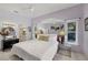 Bedroom with a large mirror, tile floors, a ceiling fan, and ensuite bathroom at 8500 Manasota Key Rd, Englewood, FL 34223