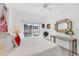 Bright bedroom features large windows, a view of the outdoor pool, and a decorative mirror at 8500 Manasota Key Rd, Englewood, FL 34223