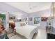 Spacious bedroom with large mirror, tile floors, a ceiling fan, and plenty of natural light at 8500 Manasota Key Rd, Englewood, FL 34223