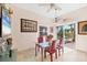 Bright dining area featuring a glass table, stylish chairs, and an access to the outdoor deck at 8500 Manasota Key Rd, Englewood, FL 34223