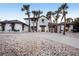 Elegant two-story home with lush landscaping, a circular driveway, and a welcoming entrance at 8500 Manasota Key Rd, Englewood, FL 34223