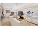 Bright kitchen features white cabinetry, an island, stainless steel appliances, and a view of the beach at 8500 Manasota Key Rd, Englewood, FL 34223