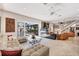 Bright living room with a comfortable sectional sofa, floor-to-ceiling mirror, and sliding glass doors to the pool at 8500 Manasota Key Rd, Englewood, FL 34223
