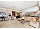 Spacious living area showcasing tile floors, large sectional sofa, a mirrored wall, and stylish decor at 8500 Manasota Key Rd, Englewood, FL 34223