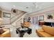 Open-concept living room featuring tile floors, stairs, and lots of comfortable seating at 8500 Manasota Key Rd, Englewood, FL 34223