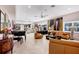 Spacious living room with a piano, plush seating, and large windows offering stunning ocean views at 8500 Manasota Key Rd, Englewood, FL 34223