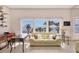Bright living room with ocean views, tile floors, and a comfortable yellow sofa at 8500 Manasota Key Rd, Englewood, FL 34223
