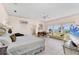 Bright main bedroom with tile floors, water views, and a sitting area at 8500 Manasota Key Rd, Englewood, FL 34223