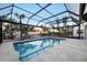 Beautiful screened pool area with tropical landscaping and views of the beach and sunset at 8500 Manasota Key Rd, Englewood, FL 34223