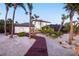 Stunning backyard featuring a wooden walkway, lush landscaping, and a screened enclosure at 8500 Manasota Key Rd, Englewood, FL 34223
