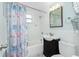 Inviting bathroom with a shower-tub combo, white subway tile, and a stylish vanity at 859 E 2Nd St, Englewood, FL 34223