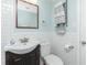 Well-lit bathroom with a dark vanity, white subway tile, and towel storage at 859 E 2Nd St, Englewood, FL 34223