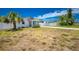 Exterior shot of a home with a driveway, white fence, and a palm tree at 859 E 2Nd St, Englewood, FL 34223