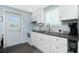 Bright updated kitchen features crisp white cabinets, stainless appliances, and a modern backsplash at 859 E 2Nd St, Englewood, FL 34223