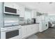 Efficient kitchen with stainless steel appliances, white cabinets and a herringbone backsplash at 859 E 2Nd St, Englewood, FL 34223