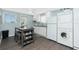 Kitchen features updated cabinets and stainless appliances, and eat in table with seating for four at 859 E 2Nd St, Englewood, FL 34223