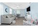 The living room features fresh paint, a ceiling fan, hardwood flooring and comfortable seating at 859 E 2Nd St, Englewood, FL 34223