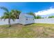 Exterior view of the backyard shed, fenced and providing convenient storage solutions at 859 E 2Nd St, Englewood, FL 34223