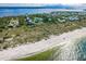 Scenic aerial view captures the beauty of a beachfront community with private beach access at 9200 Little Gasparilla # 203, Placida, FL 33946