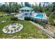Stunning coastal home featuring a private pool, outdoor lounge area, and cozy fire pit for relaxing evenings at 9200 Little Gasparilla # 203, Placida, FL 33946